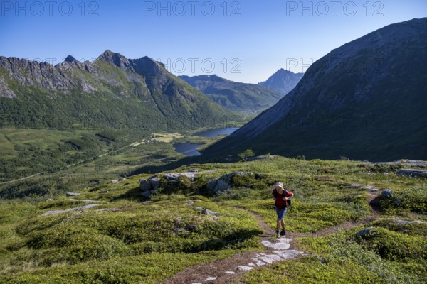 Mountaineers on a hiking trail to the summit of Rundfjellet, mountain landscape and valley with