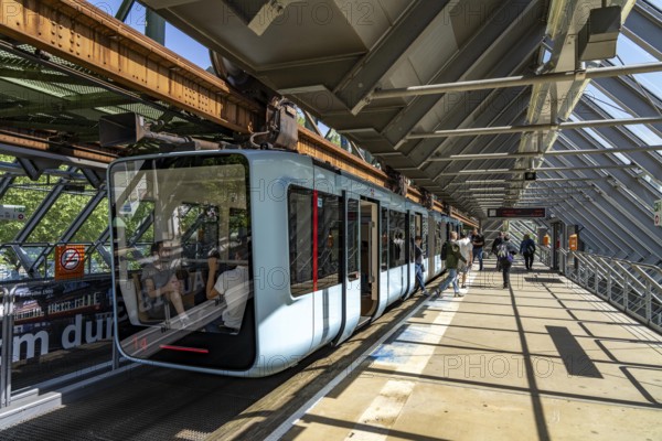 The Wuppertal suspension railway, train of the latest generation 15, floats above the Wupper,