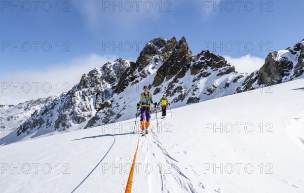 Ski tourer with rope, rope team on the Vadret da Porchabella glacier on the ascent to the summit of