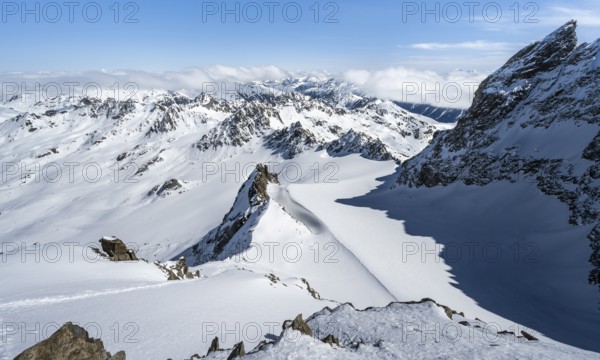 Mountain ridge of Piz Kesch, ascent on Piz Kesch or Piz d'Es-cha in winter, spectacular mountain