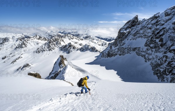 Mountaineer with ice axe and crampons, ascent through steep snowfield to Piz Kesch or Piz d'Es-cha