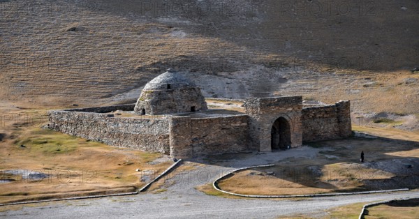 Historic caravanserai Tash Rabat from the 15th century, with yellow hills, Atbashy district in the
