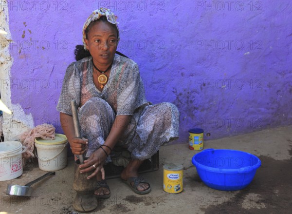 In the highlands of Abyssinia, in the village of Sina, young woman prepares coffee for the coffee