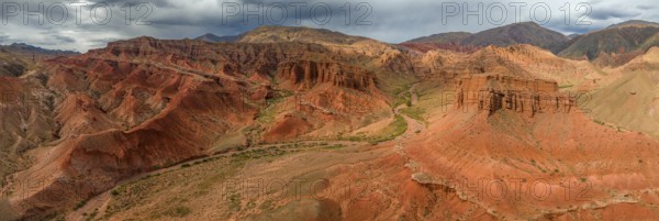 Eroded mountain landscape, canyon with red and orange rock formations, aerial view, Konorchek