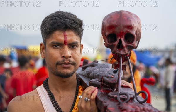 A Hindu priest arrives awith a human skull on the bank of Brahmaputra river on Ashoka Ashtami