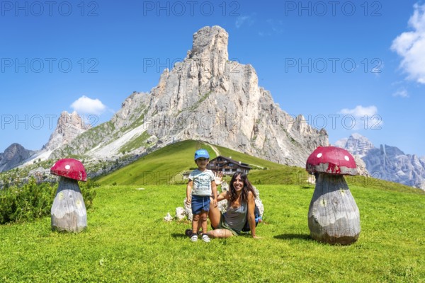 Mother and son enjoying a summer vacation in the stunning italian dolomites, surrounded by the