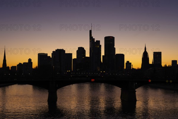 The silhouette of Frankfurt's banking skyline stands out in the evening against the residual light