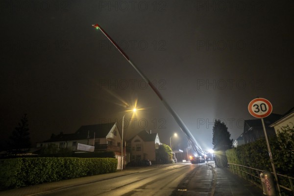 Transport of a 68 metre long, 22 tonne blade of a wind turbine, here in Breckerfeld, with a