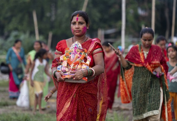 Devotees carries the Ganesha idol to immerse in the Brahmaputra river, during Ganesh Chaturthi