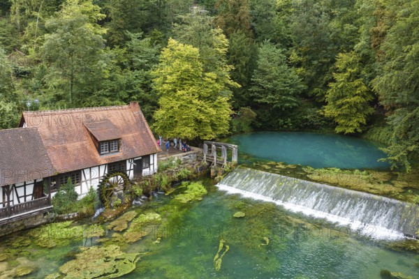 Blautopf Blaubeuren with industrial monument Hammerschmiede, source of the little river Blau in a
