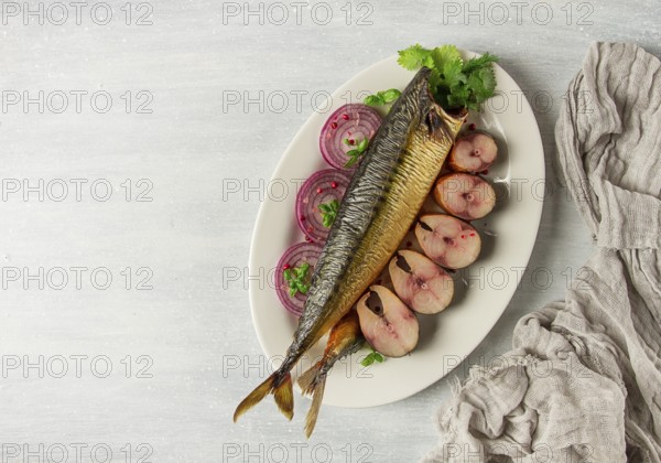 Smoked mackerel, top view, with spices, on a wooden table, no people, selective focus