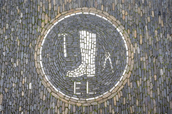 Guild coat of arms of a shoemaker as a floor mosaic in the historic centre of Freiburg, Freiburg im