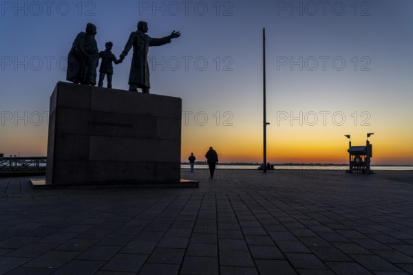 The Emigrants Monument, The Emigrants, at Willy-Brand-Platz, at the Seebäderkaje, sunset over the