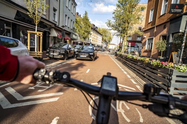 Cycling in the city, city centre road, cycle lane, two-wheeled traffic has priority, 30 km/h zone,