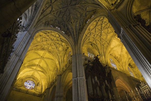 Architectural details on ceiling and stained glass rose window in Interior of The Cathedral of