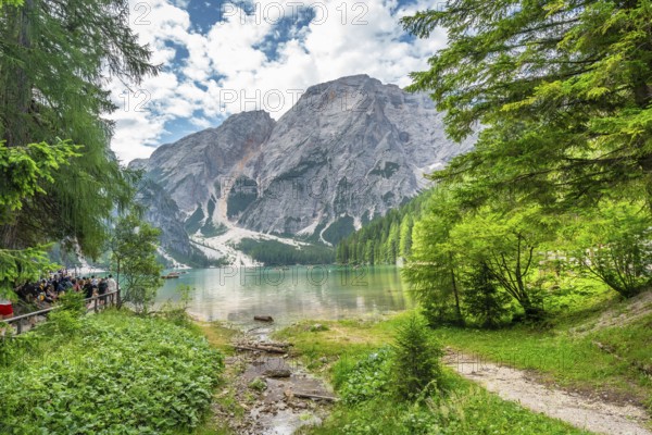 Tourists enjoying the landscape at lake braies, also called pragser wildsee, with the seekofel
