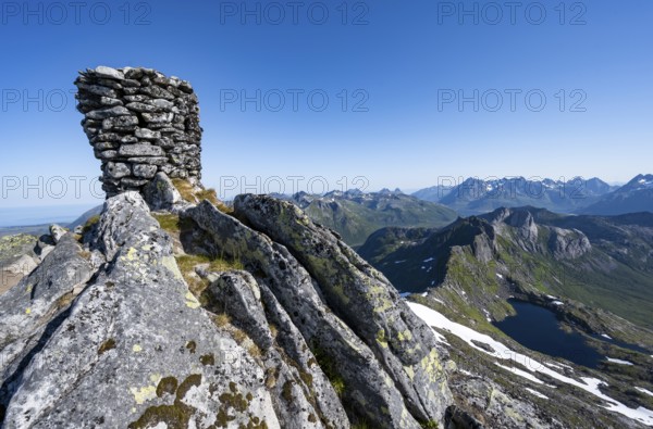 Cairn at the summit of Rundfjellet, view of mountains and fjord landscape, Svolvaer, Nordland,