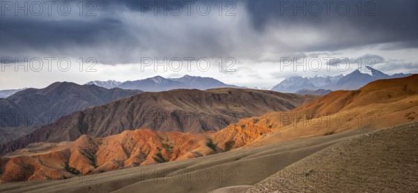 View over eroded mountainous landscape of Konorchek Canyon with red sandstone cliffs, high