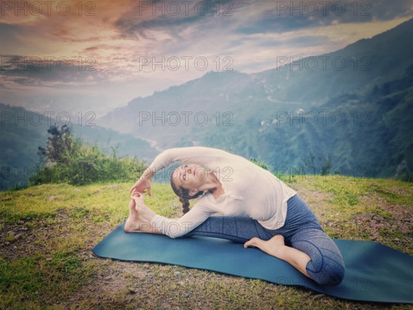 Yoga outdoors, young sporty fit woman doing Hatha Yoga asana janu sirsasana, Revolved Head-to-Knee