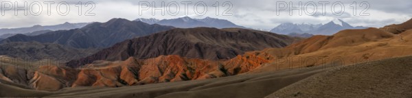 Panorama, view over eroded mountainous landscape of Konorchek Canyon with red sandstone cliffs,