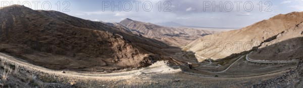 Panorama, view of mountain landscape and pass road at Tyibel Pass, Song Kul Too mountain range,