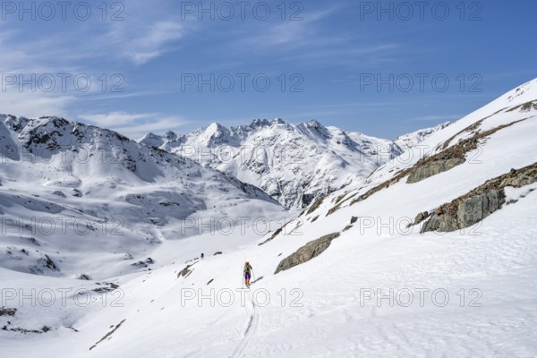Ski tourer in mountain landscape with snow, ascent to Grialetsch Scharte, Bündner Haute Route,