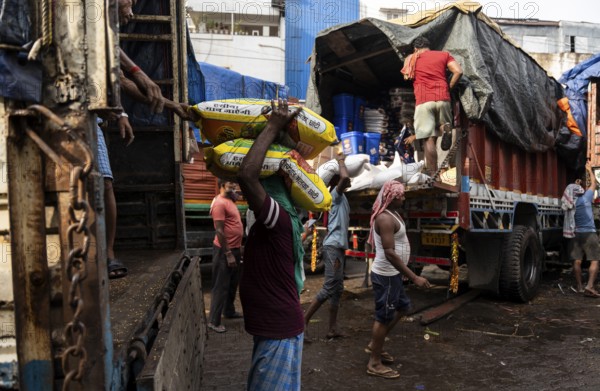 GUWAHATI, INDIA - MAY 1: Labourers carries goods in a wholesale market, in Guwahati, India, on May