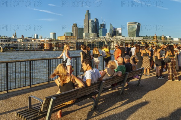 People enjoying the summer evening on the Thames near the Millenium Bridge, London, England, Great