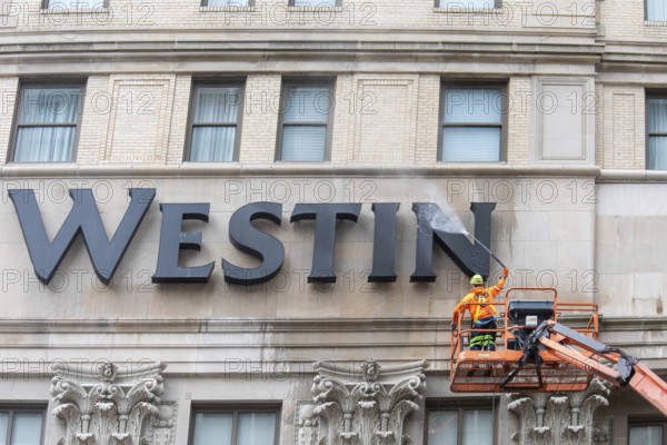 Detroit, Michigan - A worker uses a high-pressure water spray to clean the exterior of the