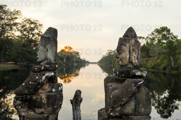 Figures on the bridge to Angkor Thom, sunset, Angkor Wat, Angkor, UNESCO World Heritage Site, Siem