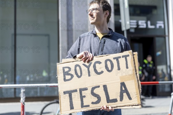 Berlin, Germany - 5 April 2025: People demonstrate against Tesla owner Elon Musk in front of a