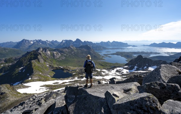 View of mountains and fjord landscape, mountain panorama, mountaineer at the summit of Rundfjellet,