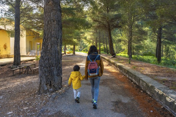 Mother and son enjoying a peaceful walk in the natural setting of the sanctuary of fontcalda in