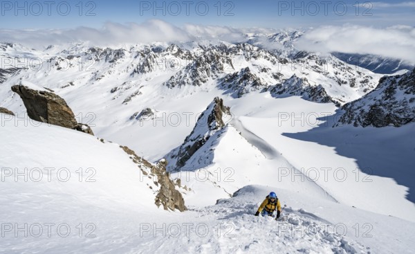 Mountaineer with ice axe and crampons, ascent through steep snowfield to Piz Kesch or Piz d'Es-cha