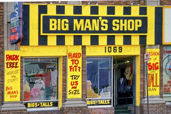 Facade of a plus size shop with eye-catching yellow and black neon sign, Big Man's Shop, retail,