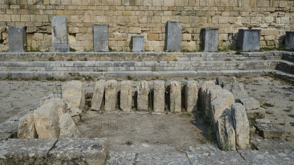 Several upright stones in an ancient archaeological excavation, ancient well house, Kamiros,