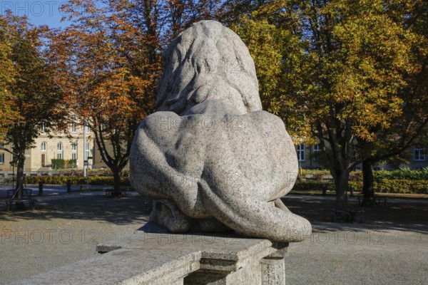 Resting lion made of granite on the terraced base of the equestrian statue of Emperor Wilhelm I on