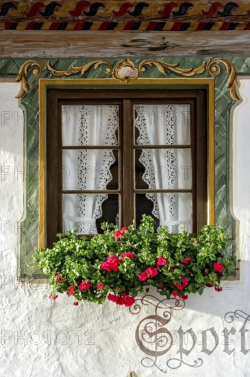 Typical Lüftlmalerei around window with geraniums, Wallgau, Werdenfelser Land, Upper Bavaria,