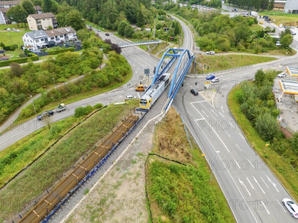 Railway line and train on a bridge over a road crossing, track construction, rail delivery for