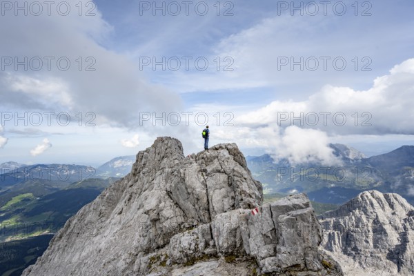 Mountaineer on a narrow rocky ridge, Watzmann crossing to Watzmann Mittelspitze, view of mountain
