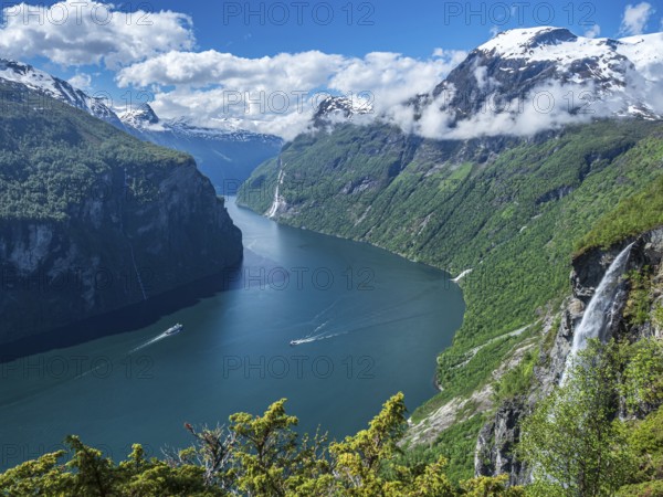 Panorama aerial view of the Geirangerfjord on a sunny spring day, waterfall Gjerdefossen, boats on
