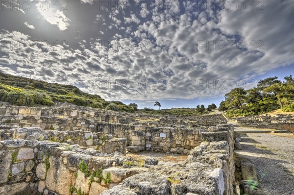 HDR, Ancient ruins with overgrown stone walls under a cloudy sky, historical site, Hellenistic