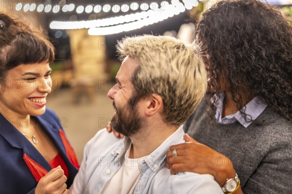 Distracted friends chatting while taking selfies during night party outdoors in the terrace of a