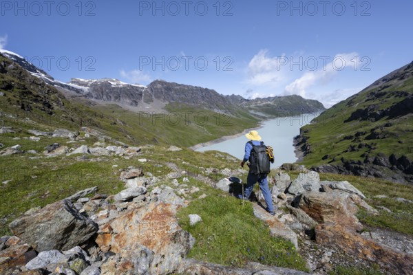 Mountaineers on a hiking trail in an idyllic mountain landscape, Lac des Dix reservoir in the