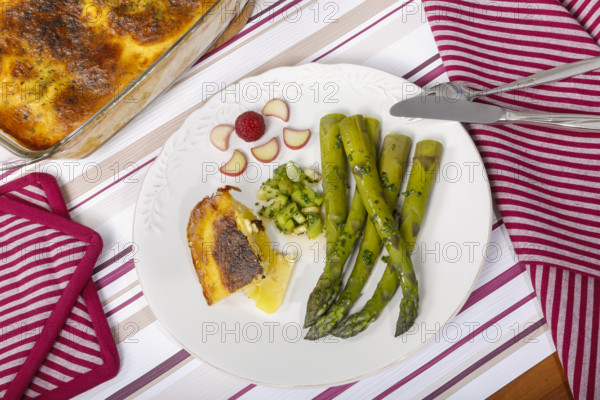 South German cuisine, green asparagus with rhubarb vinaigrette and potato gratin, healthy,