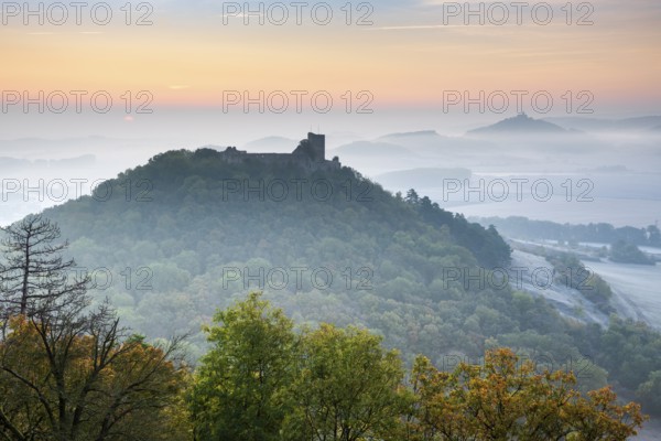 View of the ruins of Gleichen Castle at sunrise in autumn, Wachsenburg Castle in the background,