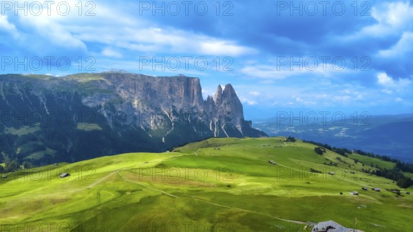 Breathtaking summer landscape featuring lush green meadows, rolling hills, and the majestic peaks