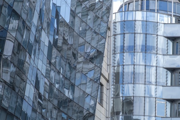 Reflective glass facades of modern office buildings with curved shapes and urban ambience, Skopje,