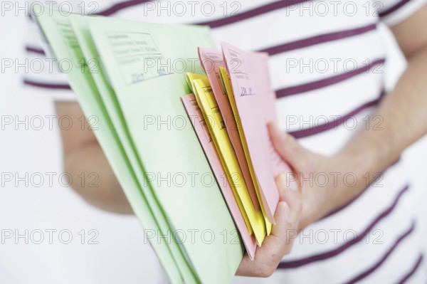 A man holds postal voting documents for the European elections, district council elections and