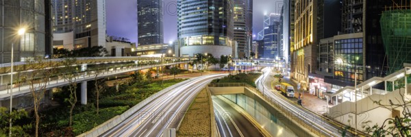 Traffic with streets and skyscrapers in the city of Hong Kong at night Panorama in Hong Kong,